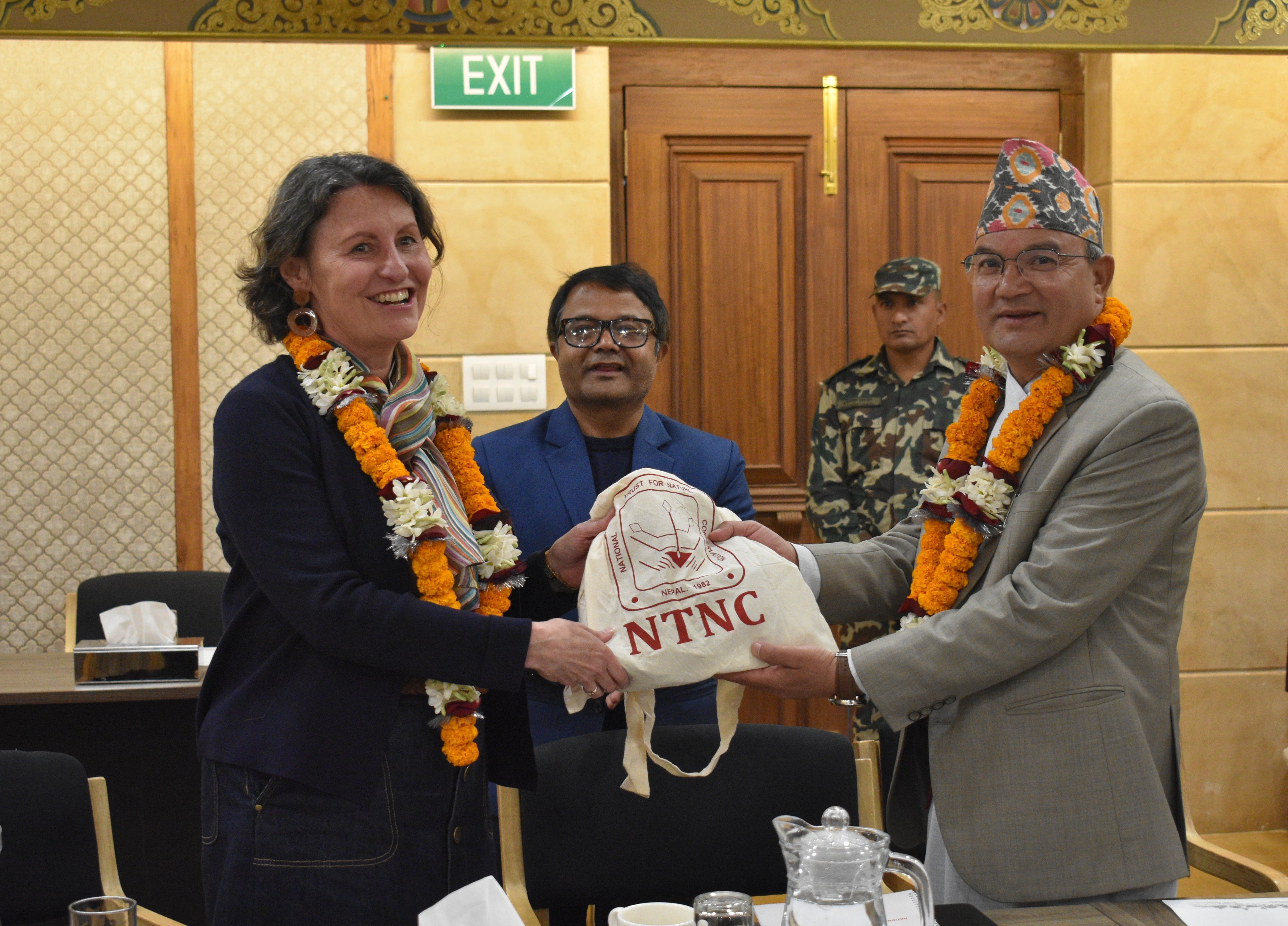Minster for Forests and Environment and Chairman of NTNC Hon’ble Ain Bahadur Shahi Thakuri, giving the token of appreciation to the Australian Ambassador to Nepal Her Excellency Leann Johnston, in the company of the NTNC Member-Secretary Dr. Naresh Subedi.
